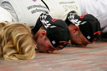 Jimmie Johnson kisses the bricks at Indy Jimmie Johnson and crew celebrate by smooching the bricks at Indy